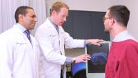 Physicians meet with a patient